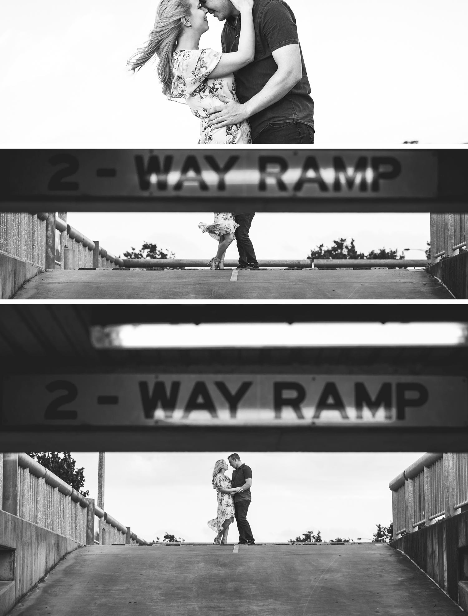Couple Embracing Car Park Engagement Shoot, Wide Angle Shot of Bride and Groom Embracing by Danae Studios