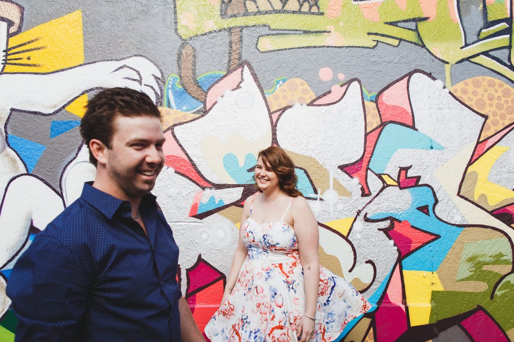 Gippsland Graffiti Wall, Urban Alley Engagement Shoot Victoria, Couple Standing by Graffiti Art Photo by Danae Studios